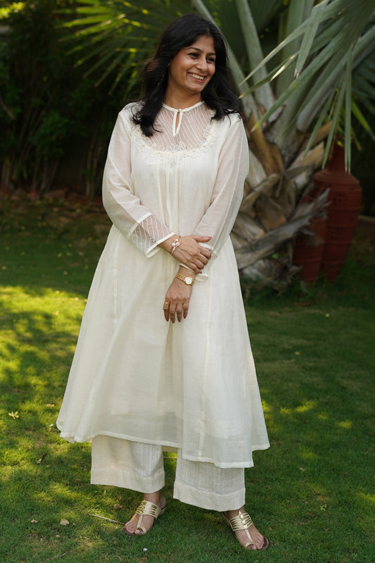 Chanderi kurta and pant with tucks yoke and embosed flower embroidery, organza scalloped flower emb.